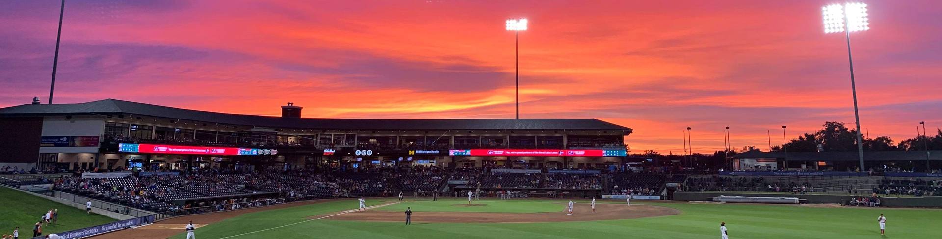 A sunset over Dow Diamond during a Great Lakes Loons baseball game